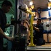 Sailors re-wrap cable reel in the hangar bay of USS John C. Stennis (CVN 74)