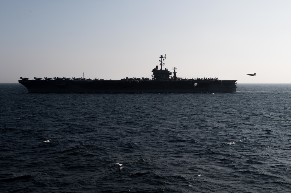 An F/A-18 Super Hornet prepares to land on the flight deck of the aircraft carrier USS John C. Stennis (CVN 74)