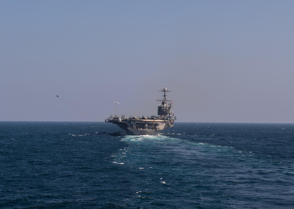 Two F/A-18 Super Hornets take off from the flight deck of the aircraft carrier USS John C. Stennis (CVN 74)