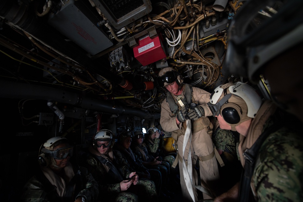 The aircraft carrier USS John C. Stennis (CVN 74) and the amphibious assault ship USS Essex (LHD 2) conduct a cross deck evolution