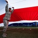 Nellis, Creech Airmen wave half-ton American flag for Las Vegas Bowl