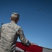 Nellis, Creech Airmen wave half-ton American flag for Las Vegas Bowl
