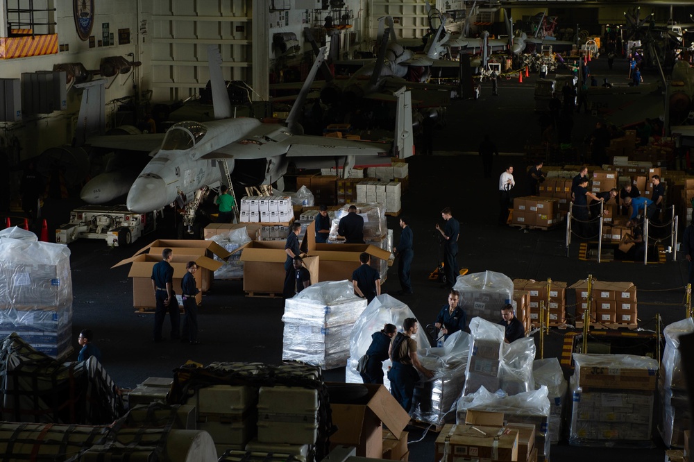 U.S Sailors move cargo during a replenishment-at-sea