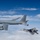Two U.S. Air Force F-22 Raptors fly next to a KC-135 Stratotanker