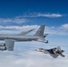 Two U.S. Air Force F-22 Raptors fly next to a KC-135 Stratotanker