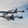 KC-135 Stratotanker and F-22 Raptors conduct aerial refueling