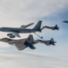 KC-135 Stratotanker and F-22 Raptors conduct aerial refueling