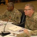 DLA Director Army Lt. Gen. Darrell K. Williams (left) and DLA Troop Support Commander Brig. Gen. Mark Simerly (right) listen senior leaders review the Troop Support operating plan at DLA Troop Support in Philadelphia Dec. 7, 2018.