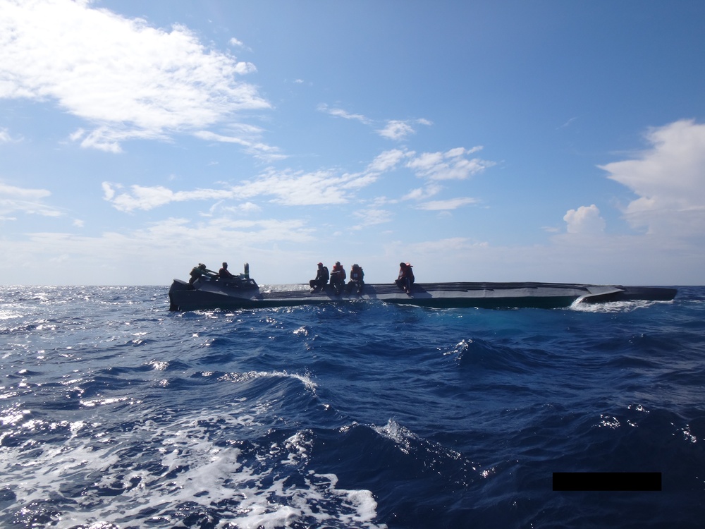 Coast Guard Cutter Campbell crew with suspected drug smuggling boat