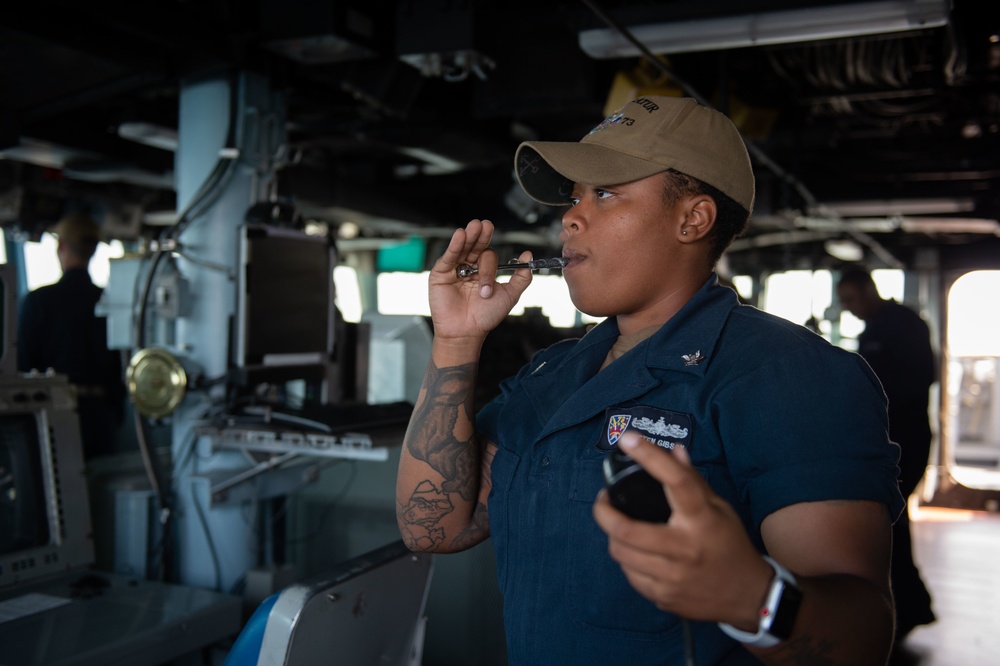 U.S. Sailor blows a boatswain’s pipe aboard USS Decatur (DDG 73)