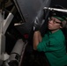 U.S. Sailor sands an F/A-18E Super Hornet aboard the aircraft carrier USS John C. Stennis (CVN 74)