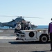Members of the French military walk across the flight deck aboard the aircraft carrier USS John C. Stennis (CVN 74)
