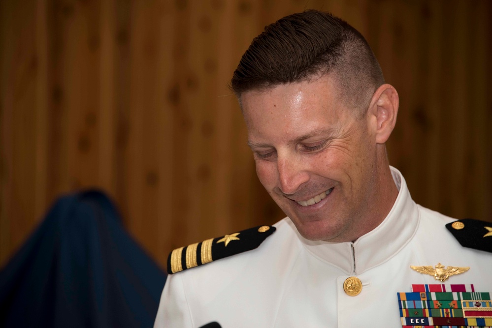 Naval Air Facility Atsugi Operations Officer Cmdr. Eric Lindgren prepares to pass through sideboys during his retirement ceremony.
