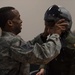 Airman places helmet on Brian Rubio's head during pilot for a day tour