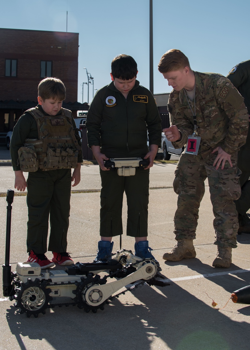 Airman Guides Brothers on How to Use EOD Robot