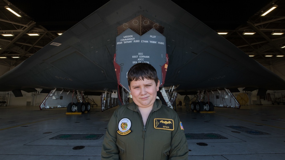 Brian Rubio poses for a photo in front of B-2 for pilot for a day tour