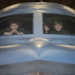 Brothers stare out of B-2 cockpit during pilot for a day tour