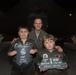Ziegler poses with brothers Brian and Ethan Rubio in front of the B-2 Spirit Stealth Bomber
