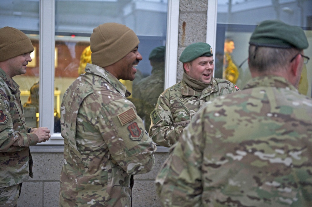 Staff Sgt. Brendan Richmond, left, and Tech. Sgt. Gregory Myers share a laugh with Danish soldiers