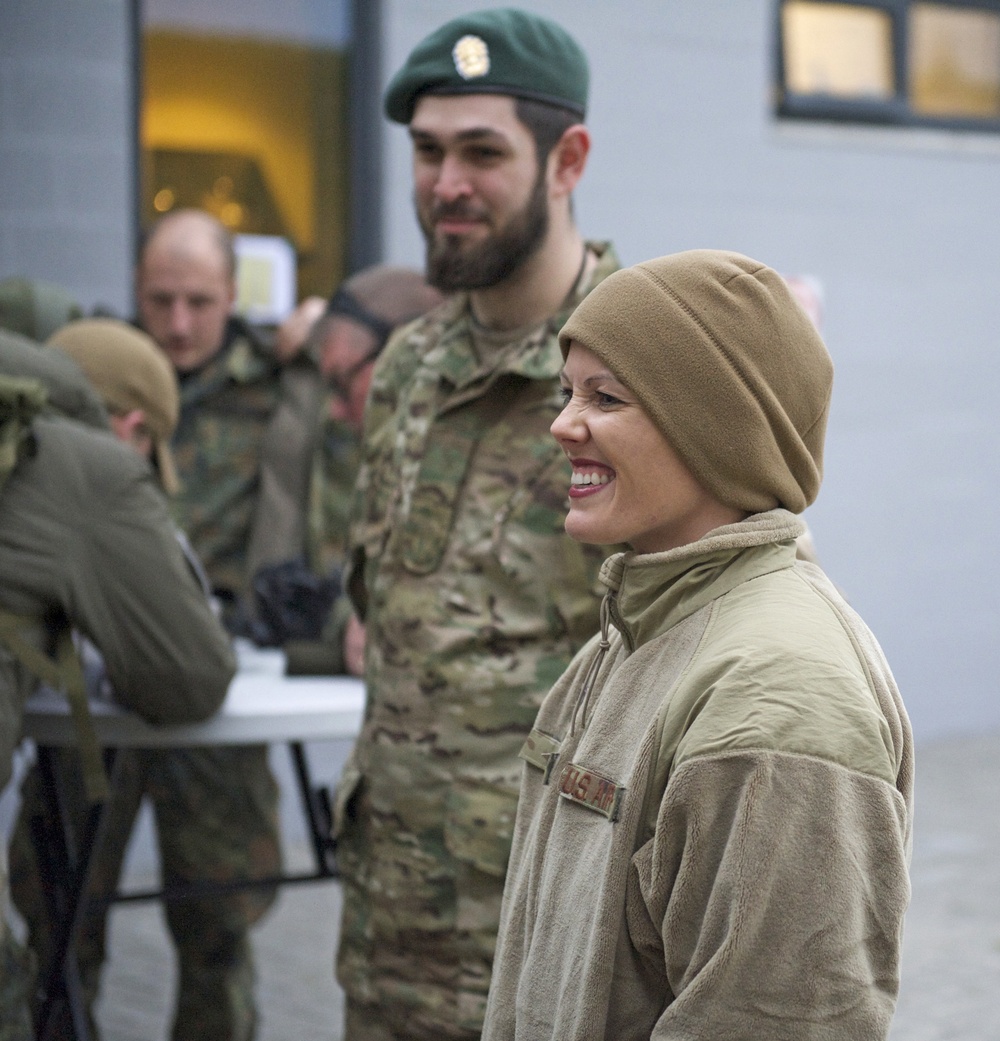 Tech. Sgt. Jessica Rayl smiles as a Danish soldier looks on