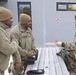 Senior Master Sgt. Aaron Doss, left, and Tech. Sgt. Gregory Myers, trade patches with a Danish soldier