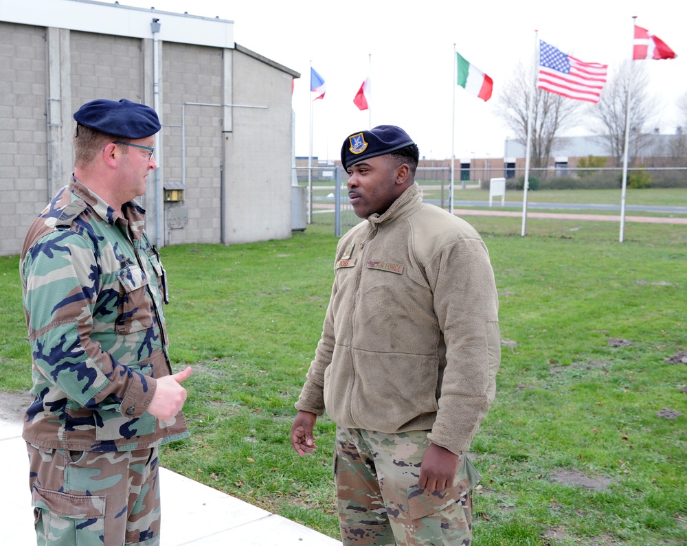 Senior Master Sgt. Aaron Doss, Combat Arms Functional Manager for AFRC, right, speaks with SGT Marn Eric Commandeur