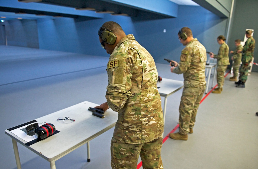 Tech. Sgt. Gregory Myers, left, loads his weapon alongside the rest of the Air Force Reserve Command Shooting Team