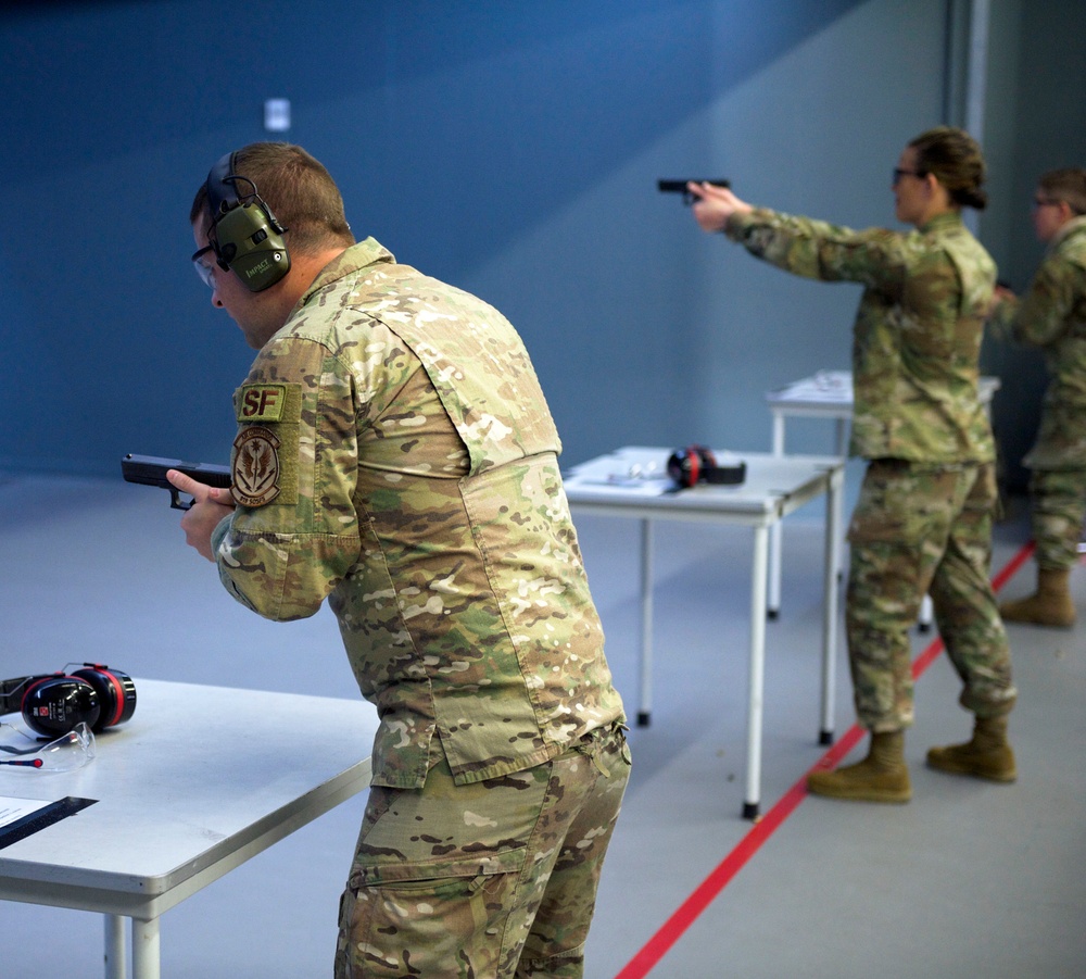 Staff Sgt. Brendan Richmond, left, prepares to fire