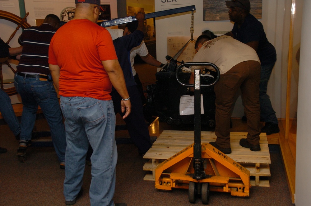 DLA staff members carefully move Naval Museum's larger artifacts