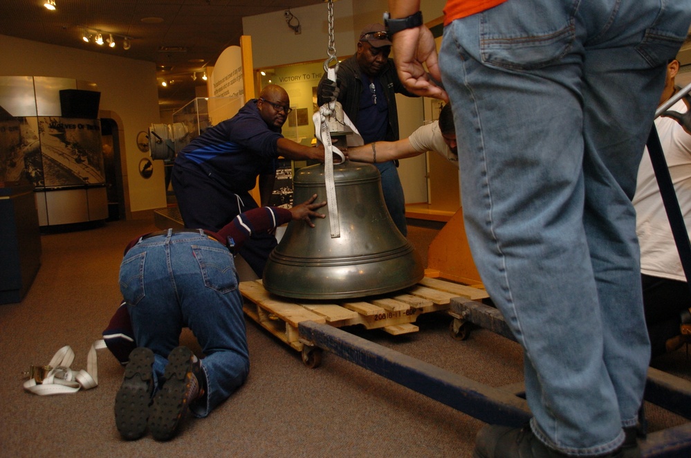 DLA staff members carefully move Naval Museum's large artifacts