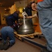 DLA staff members carefully move Naval Museum's large artifacts