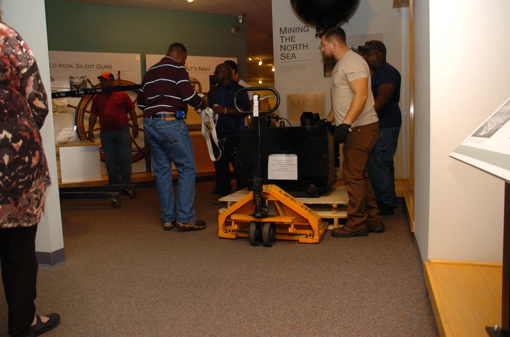 DLA staff members carefully move Naval Museum's larger artifacts