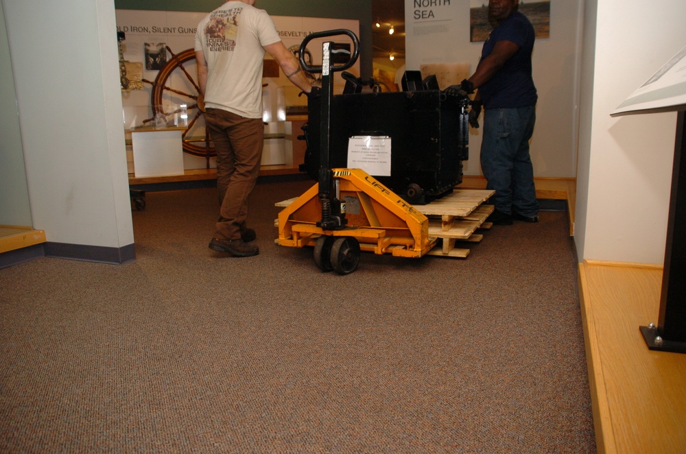DLA staff members carefully move Naval Museum's larger artifacts