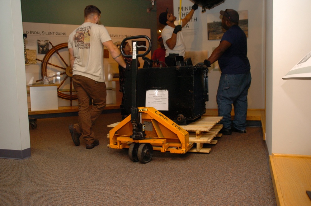 DLA staff members carefully move Naval Museum's larger artifacts