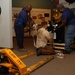 DLA Staff members carefully move Naval Museum's larger artifacts