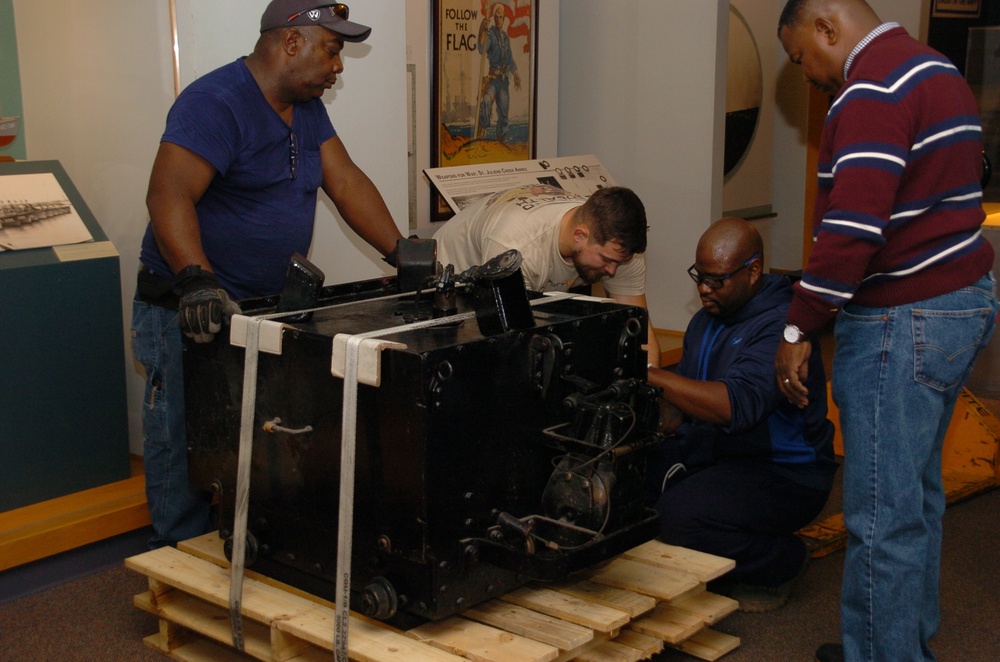 DLA staff members carefully move Naval Museum's larger artifacts
