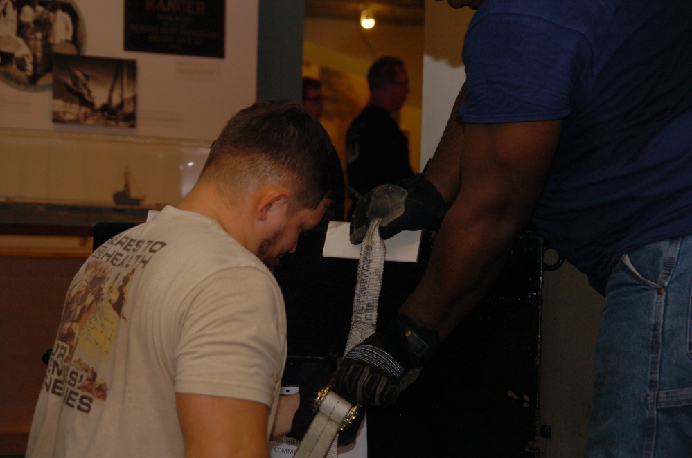 DLA staff members carefully move Naval Museum's larger artifacts