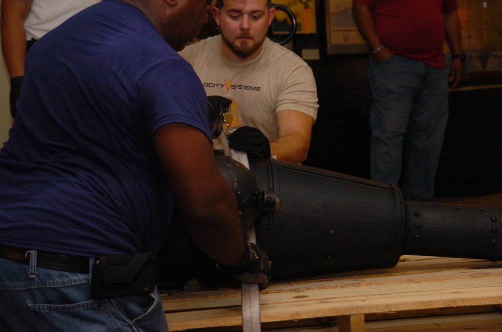 DLA staff members carefully move Naval Museum's larger artifacts