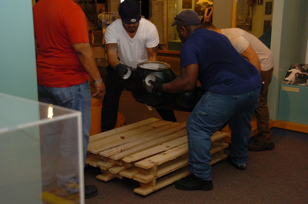 DLA staff members carefully move Naval Museum's larger artifacts