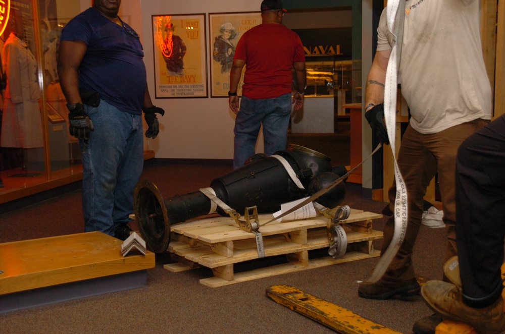 DLA staff members carefully move Naval Museum's larger artifacts