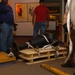 DLA staff members carefully move Naval Museum's larger artifacts