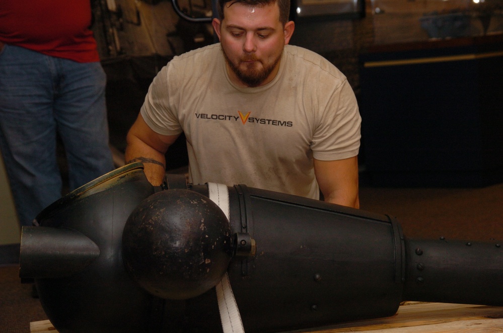 DLA staff members carefully move Naval Museum's larger artifacts