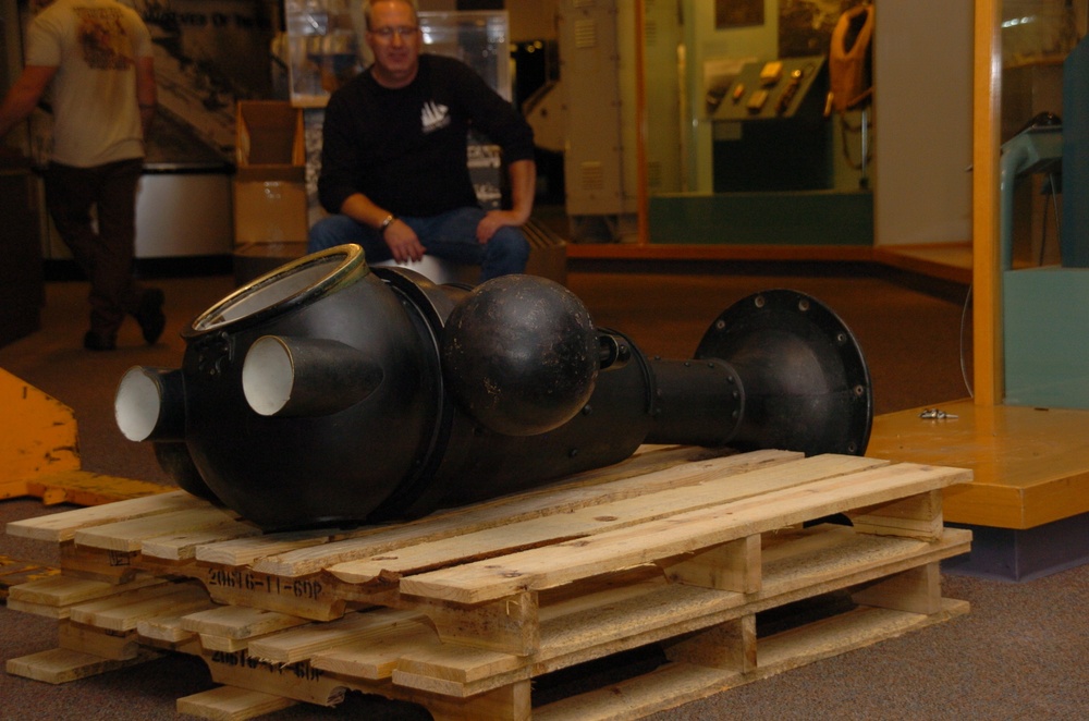 DLA staff members carefully move Naval Museum's larger artifacts