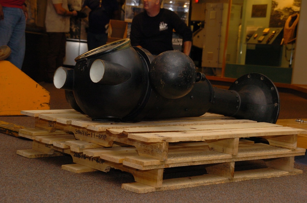 DLA staff members carefully move Naval Museum's larger artifacts