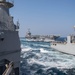 USS Mobile Bay and USS John C. Stennis conduct a replenishment-at-sea with USNS Charles Drew