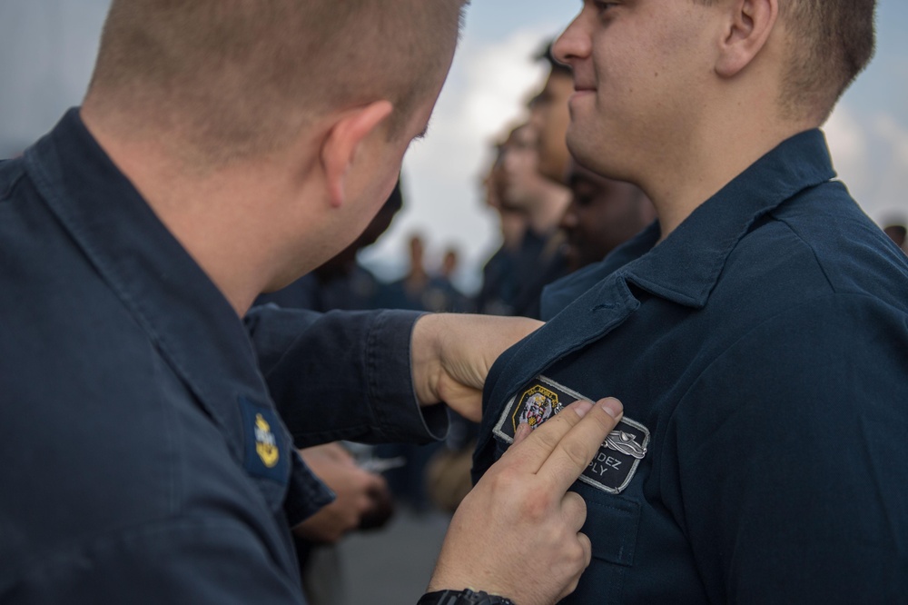 U.S. Navy Sailors receive their enlisted surface warfare specialist pin (ESWS)