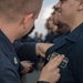 U.S. Navy Sailors receive their enlisted surface warfare specialist pin (ESWS)