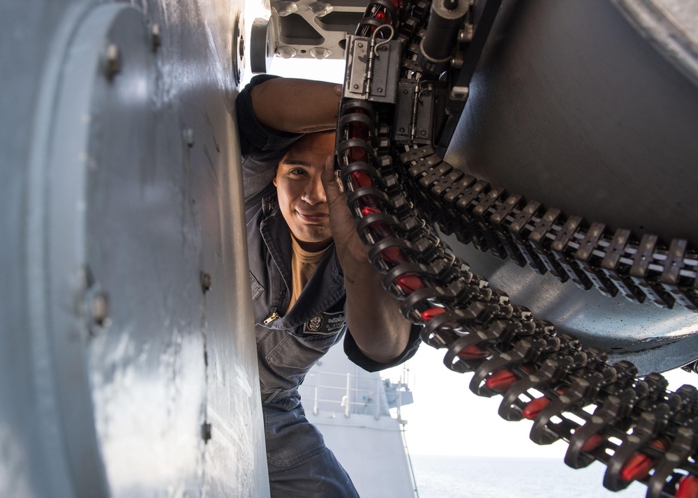 U.S. Navy Fire Controlman 2nd Class Deniz Sanchez, from Brentwood, New York, inspects the ammunition system of a Mark-15 Phalanx close-in weapon system