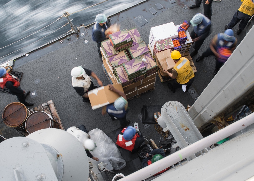 U.S. Navy Sailors transport food and supplies aboard USS Mobile Bay