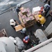 U.S. Navy Sailors transport food and supplies aboard USS Mobile Bay